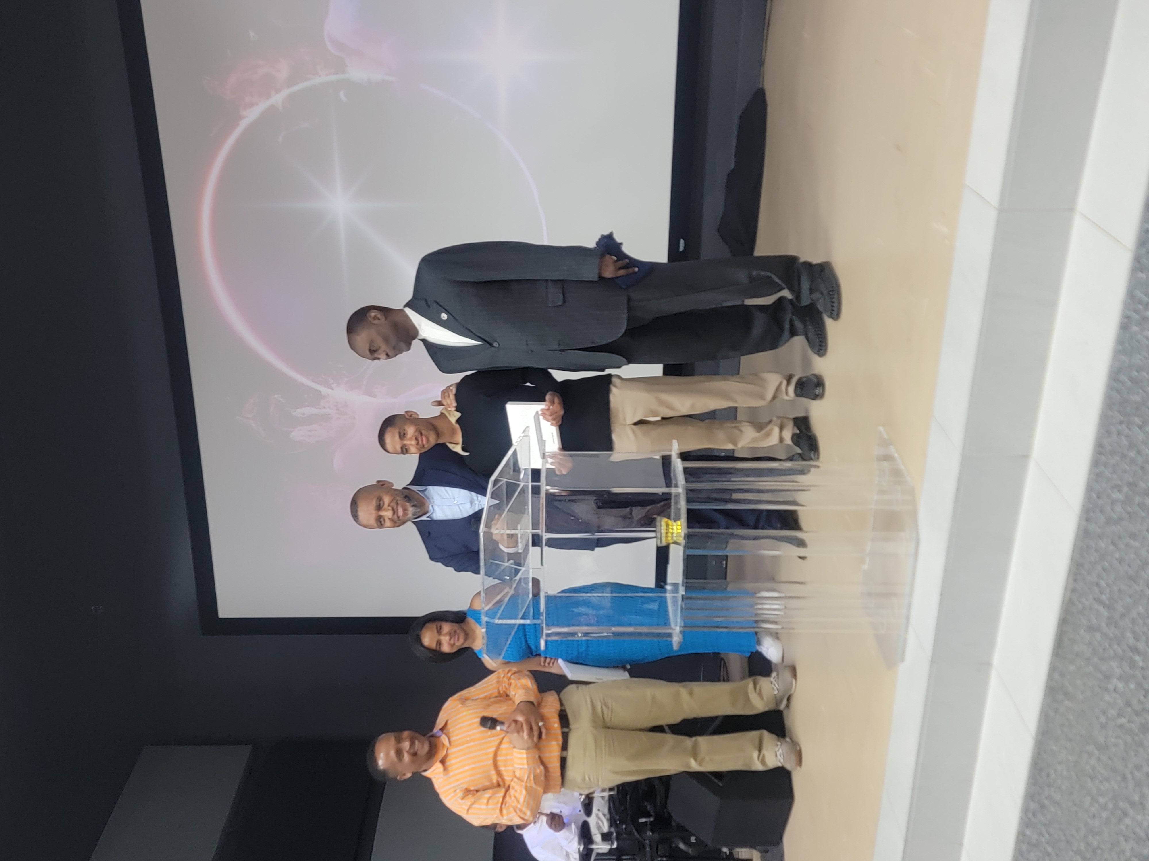 Group of recipients and leaders standing together on stage after the give-away